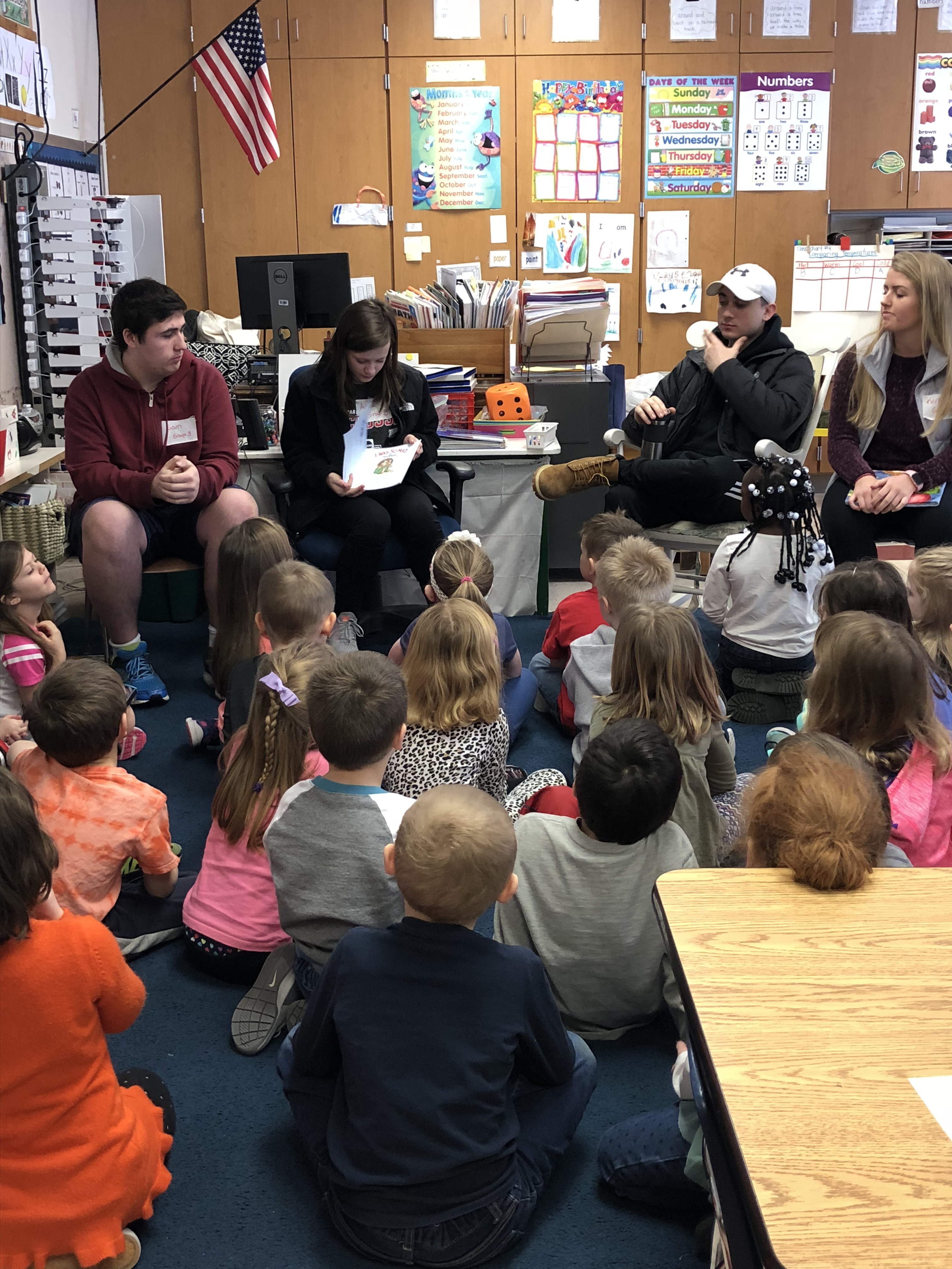 HS students reading to Kindergarten students