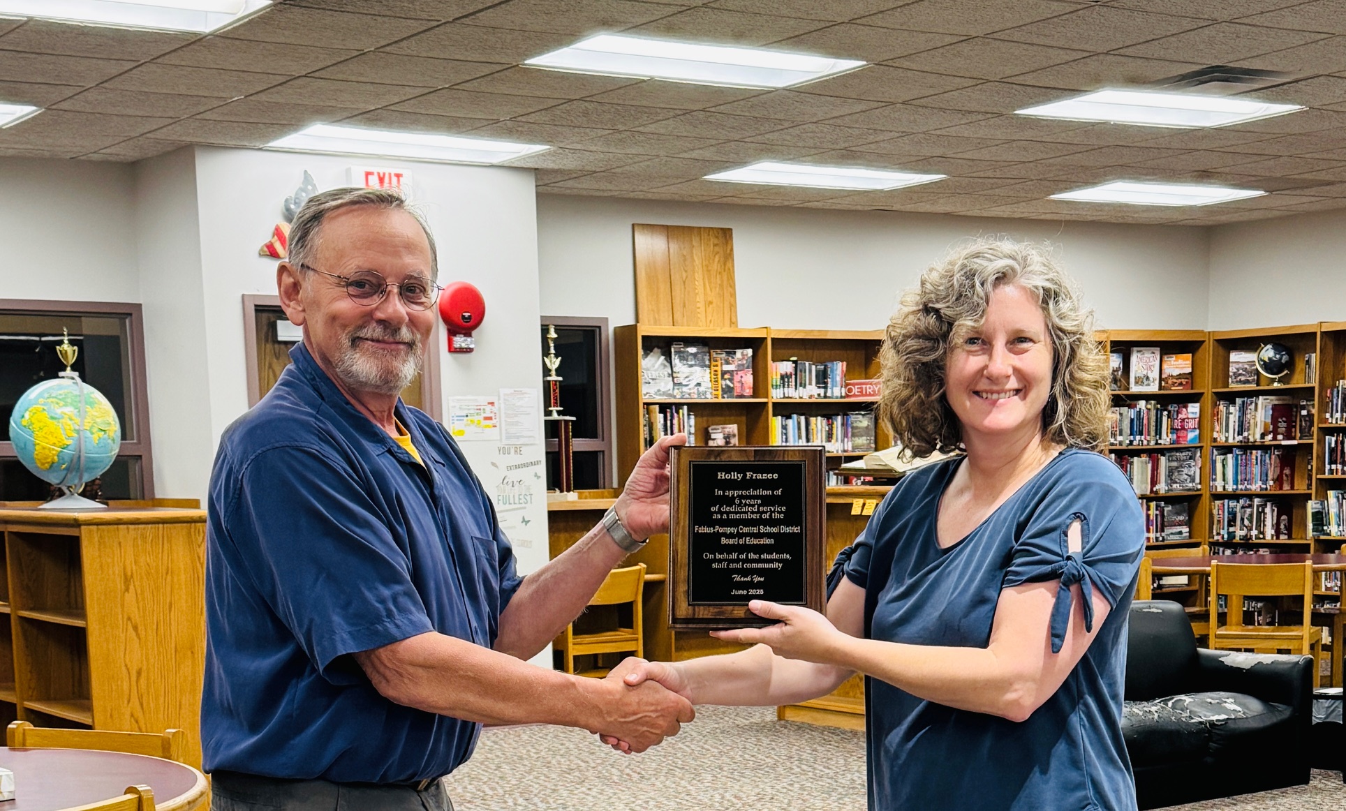 John Repak and Holly Frazee with award