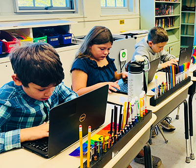 Fabius-Pompey students using laptops