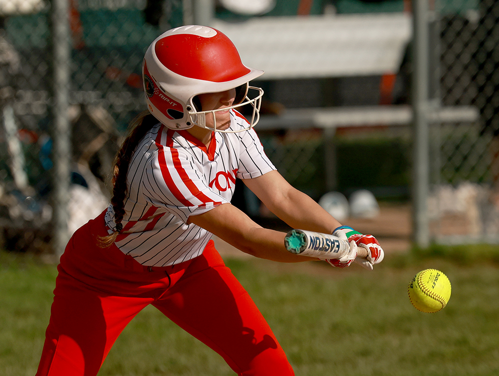 Fabius-Pompey softball player hitting ball